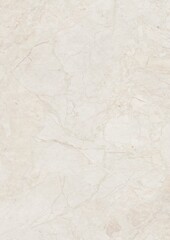 Close-up of a light beige marble surface with natural veining patterns