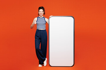 Full body young woman she wear blue tank top casual clothes big huge blank screen mobile cell phone...