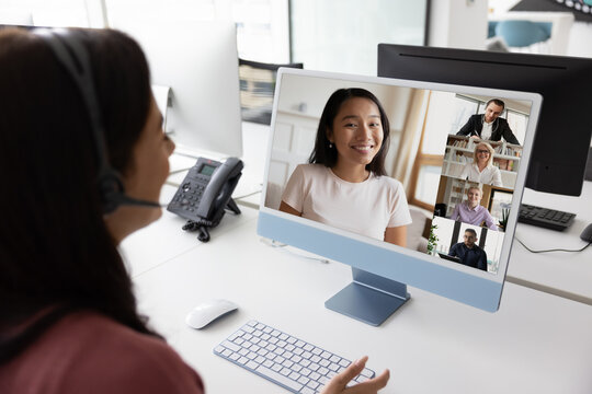 Fototapeta Woman conducting video call with multinational colleagues