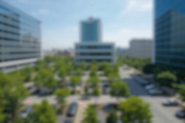 Fuzzy backdrop featuring dense greenery in a neatly arranged city parking area encircled by contemporary office structures under a bright sky.
