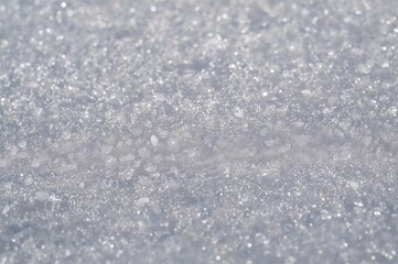 Obraz premium Close-up shot of pristine snow glistening under bright winter sunlight. Enjoying a peaceful stroll in the outdoors, feeling joyful. Scenic natural environment captured in photography.