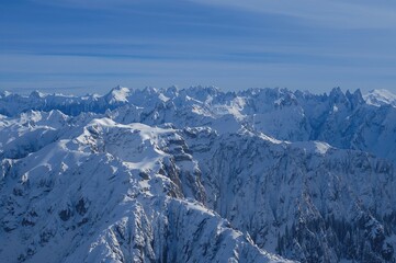 Enchanting snowy mountain scenes with sparkling white peaks forming a breathtaking horizon beneath the frosty sky