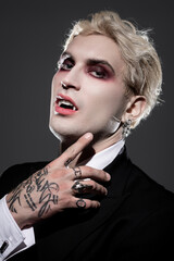 Obraz premium Handsome young man showcases unique Halloween costume with striking makeup and modern flair