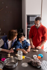 Grandmother, father and child baking Christmas cookies at home, enjoying family time and holiday traditions.