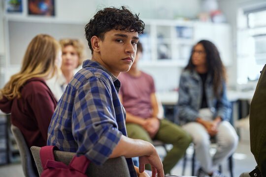 Hispanic student guy in support group discussion at school