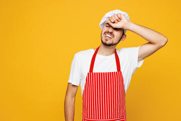 Young sad mistaken shocked housewife housekeeper chef cook baker man he wear red apron toque hat...
