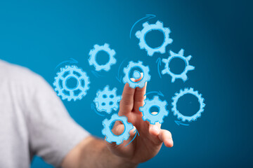 Abstract image of hand interacting with gears, symbolizing teamwork, strategy, and process optimization.