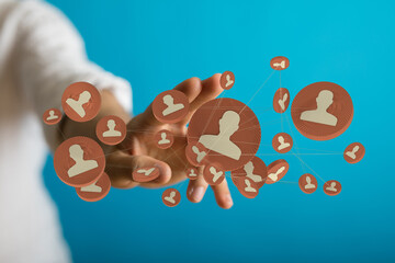 Hand reaching out connecting digital people icons. Conceptual image illustrating social network and modern communication. (140 chars max)
