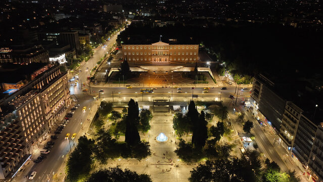Aerial drone night shot from famous illuminated Syntagma square and Greek Parliament  building, Athens historic centre, Attica, Greece