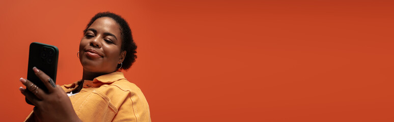 Trendy autumn outfit highlights body positivity in a stylish studio setting