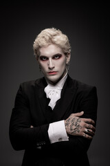 Handsome young man showcases epic Halloween costume with striking details and bold makeup