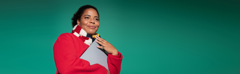 Stylish plus size woman showcases autumn fashion in a vibrant studio setting