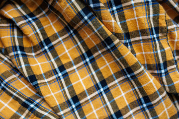 Yellow tartan flannel fabric with black, white and blue check pattern, soft cotton textile with brushed surface, cozy autumn and winter cloth background