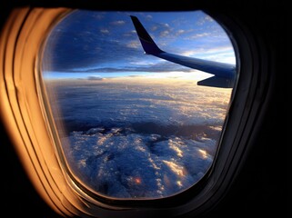 Naklejka premium Airplane window view of clouds and sky at sunrise/sunset