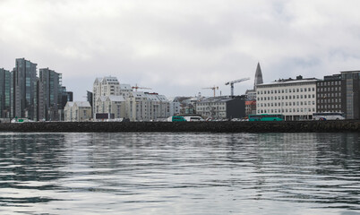 Obraz premium Reykjavik, Iceland. A calm harbor scene with a modern city skyline