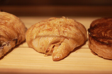 Freshly baked croissants on a wooden tray