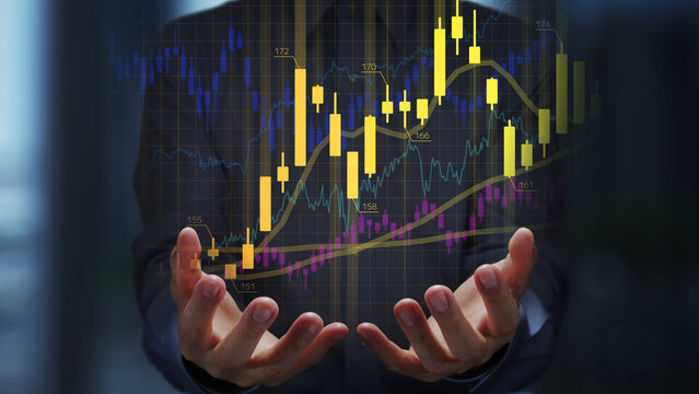 Stock trading strategies and technical analysis. Candlestick charts and data graphs of the financial market. Trader holding charts.