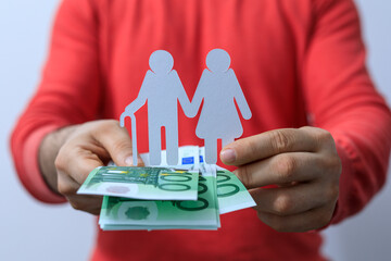 Conceptual image representing financial security for the elderly with a paper cutout couple and...