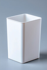 Naklejka premium Minimal White Square Trash Bin on Neutral Gray Background