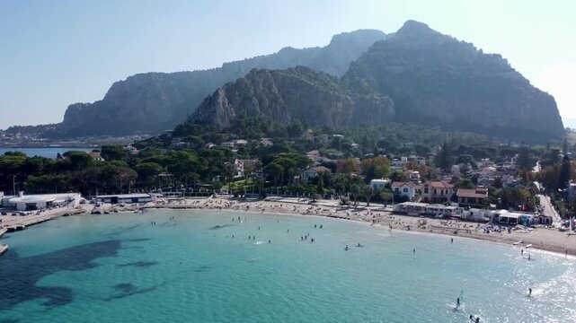 Aerial 4k drone footage of Spiaggia di Mondello in Sicily, Italy, featuring pristine sandy beaches, crystal-clear turquoise sea, coastal scenery, and Mediterranean landscapes