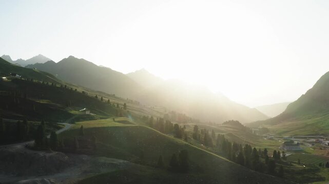 Drone shot through soft morning mist and light over a mountainous region near K&uuml;htai. Ideal for intros, transitions, or poetic nature edits.