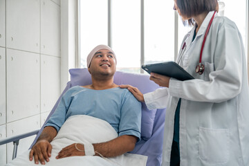 Obraz premium A male cancer patient in a wheelchair receives IV therapy while a female doctor offers care encouragement and updates on his test results providing support and discussing health progress
