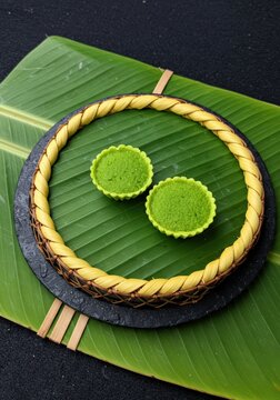 Traditional Southeast Asian Pandan and Coconut Pudding Dessert Served in Small Leaf Parcels for Traditional Food Culture