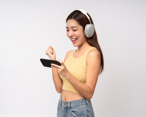 Happy young asian woman using cellphone standing on isolated white background. Happy Excited...