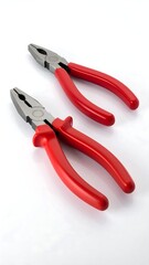 Obraz premium Two pairs of pliers, one slightly larger than the other, with red handles and metal jaws, are angled on a white background