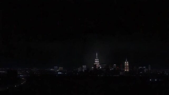 Lightning Storm Striking Over City Skyline During Night with Dramatic Cloud Cover