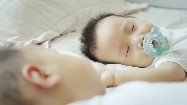 Two twin babies enjoying their midday nap