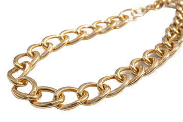 A chunky gold-colored fashion chain with oval links, curved and isolated against a clean white background