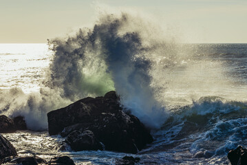 Wave crashing into rocks of Atlantic Ocean shore in Nevogilde area of Porto city, Portugal
