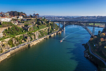 Obraz premium View from Infante D. Henrique Bridge on a Maria Pia Bridge old railway bridge in Porto, Portugal