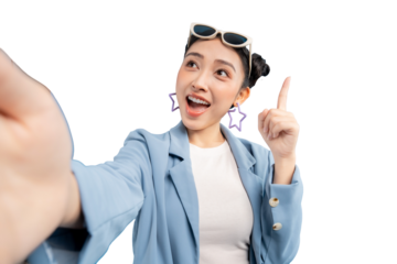 Young Asian woman taking a selfie with an excited expression, pointing upwards, with glasses