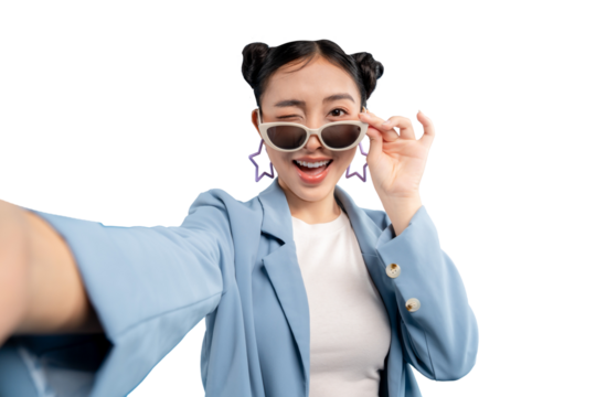 Young Asian woman wearing sunglasses and winking while taking selfie. Capture the vibrant expression and playful interaction PNG
