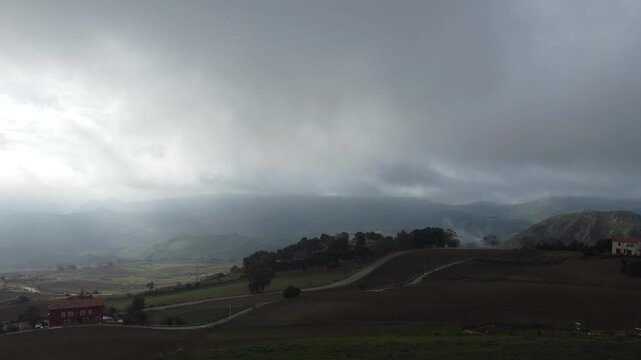 Aerial 4k drone footage of Mussomeli Castle in Sicily, Italy, featuring the historic fortress, dramatic misty atmosphere, surrounding hills, and panoramic views of the landscape