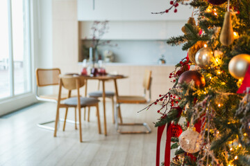 Classical Christmas decorated interior kitchen. Modern classic style interior design apartment dining room and Christmas tree with red golden ornament decorations. Christmas eve at home