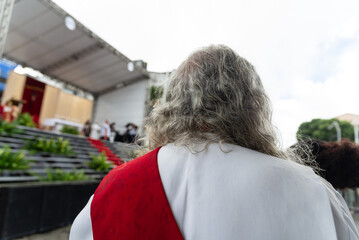 A Catholic priest is seen with his back turned during Palm Sunday mass.