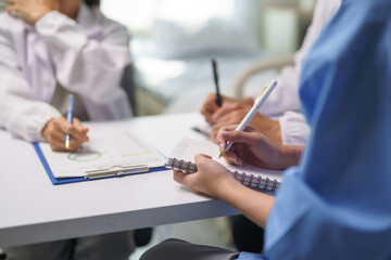 Medical Team Meeting, Doctors Taking Notes During Briefing Session © Crystal