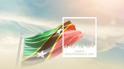 Saint Kitts and Nevis flag waving proudly under a bright sky with text happy independence day....