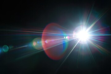 Obraz premium A vibrant burst of light illuminates a dark background, displaying lens flares and color refraction