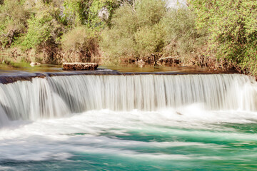 wide waterfall on the river, blurred movement of water