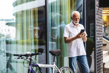 Bike travel, nature and a businessman with a phone for an email, reading communication and chat. Relax, commute and a mature employee with a bicycle and a mobile for a notification in the morning.