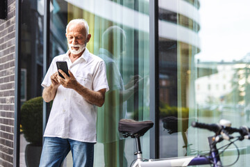 Businessman, phone with bicycle in city on social media, web or internet browsing. Tech, bike or senior manager on 5g smartphone app, networking or text message on break.