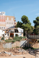 Damaged homes along river after flash flood in Valencia, one year after the DANA floods