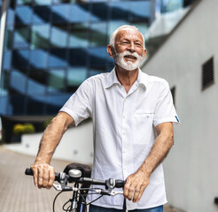 Portrait, business and mature man with bike, travel and confident with background, startup and eco friendly.. Businessman commuter pushing his bicycle on the street on his way to work.