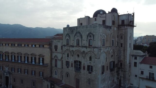 Aerial 4k drone footage of Palazzo dei Normanni in Palermo, Sicily, Italy, showcasing the historic royal palace, Cappella Palatina, surrounding gardens, and panoramic views of the city.
