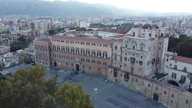 Aerial 4k drone footage of Palazzo dei Normanni in Palermo, Sicily, Italy, showcasing the historic royal palace, Cappella Palatina, surrounding gardens, and panoramic views of the city.
