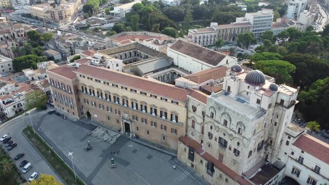 Aerial 4k drone footage of Palazzo dei Normanni in Palermo, Sicily, Italy, showcasing the historic royal palace, Cappella Palatina, surrounding gardens, and panoramic views of the city.